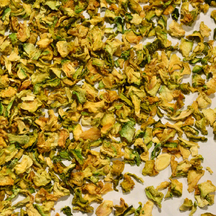 A close-up of Whole Spice Inc. Zucchini Dices, showing green and yellow, slightly wrinkled pieces spread out—ideal for zucchini soup or baking.
