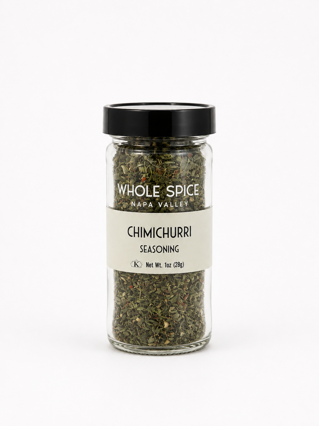 A glass jar of Whole Spice Inc. Chimichurri Seasoning, inspired by the renowned South American sauce and containing a blend of dried green herbs ideal for enhancing grilled meats. The jar is topped with a black lid and features a white label with product details.