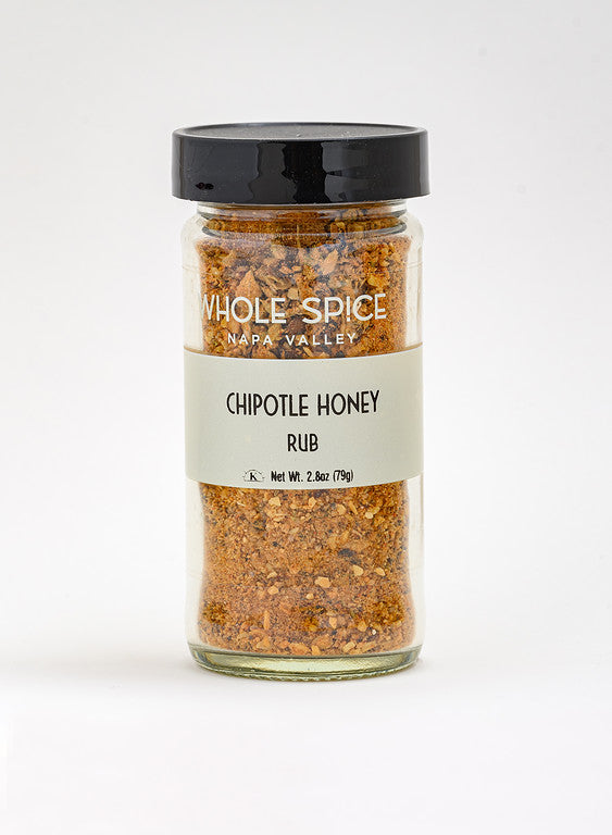A 2.8 oz (79g) glass jar of Whole Spice Inc. Chipotle Honey Rub with a black lid, containing a reddish-brown barbecue blend featuring hickory smoked sea salt.