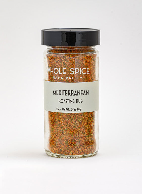 A clear jar with a black lid labeled Whole Spice Inc. Mediterranean Roasting Rub, containing reddish-brown seasoning with kosher salt, net weight 2.4 oz (68g), is shown against a plain white background.