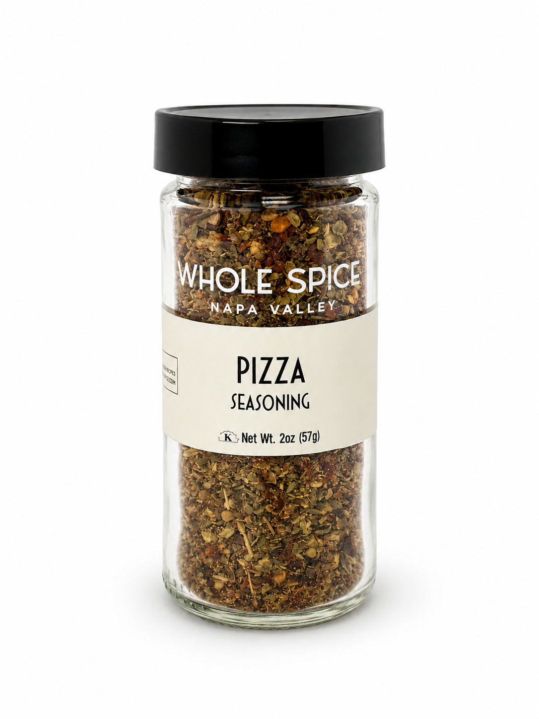 A clear glass jar labeled Whole Spice Inc. Pizza Seasoning, topped with a black lid and filled with a flavorful blend of dried herbs and spices ideal for enhancing pizza or pasta sauces, stands against a white background. The net weight is 2 oz (57 g).
