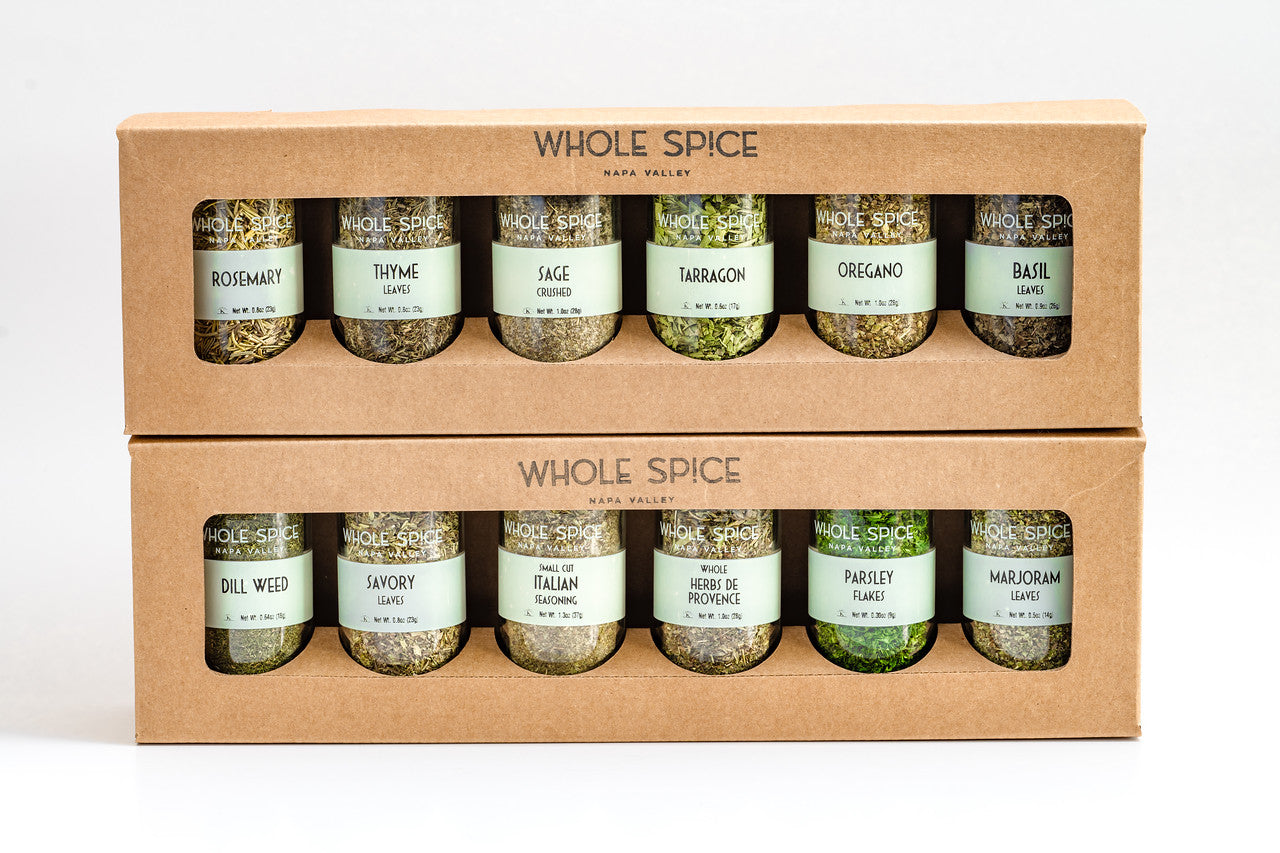 The Whole Spice Herbs Jar Set by Whole Spice Inc. features ten premium glass jars with whole spices and herbs like rosemary, thyme, sage, tarragon, oregano, basil, and more in two stacked boxes with clear windows.
