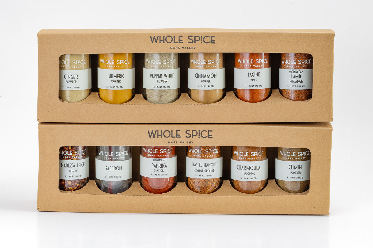 The Whole Spice Moroccan Spice Gift Set by Whole Spice Inc. includes two boxes, each with six glass jars of authentic Moroccan spices like ginger, turmeric, white pepper, cinnamon, chamomile, cumin, harissa spice, saffron, paprika, and ras el hanout.