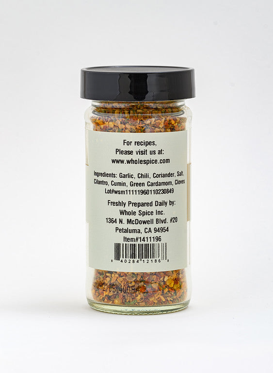 Zhug Spice by Whole Spice Inc. comes in a clear glass jar with a black lid and a label listing garlic, chili, coriander, and cumin—core Yemenite blend ingredients—with company contact info in Petaluma, CA.