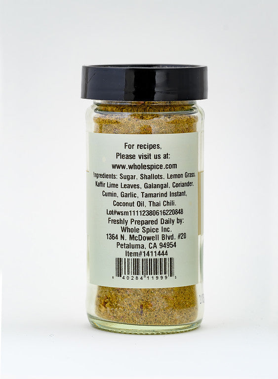 A clear glass jar of Whole Spice Inc. Thai Seasoning contains sugar, shallots, lemongrass, and more. The label features ingredients and contact info for Whole Spice in Petaluma, CA—great for adding authentic Thai flavors to your dishes.
