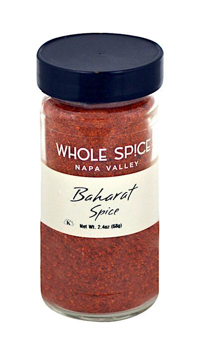 A glass jar with a black lid holds Baharat Spice, an aromatic Arabic blend by Whole Spice Inc. The label features the product name and net weight of 2.4 oz (58 g), popular in Gulf States cuisine.