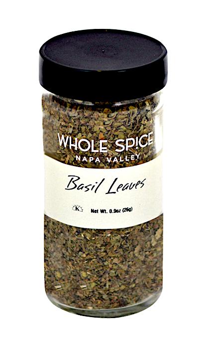 A glass jar with a black lid, labeled Whole Spice Inc. Basil Leaves, contains 0.9 oz (26g) of dried culinary basil—perfect for enhancing your favorite recipes.