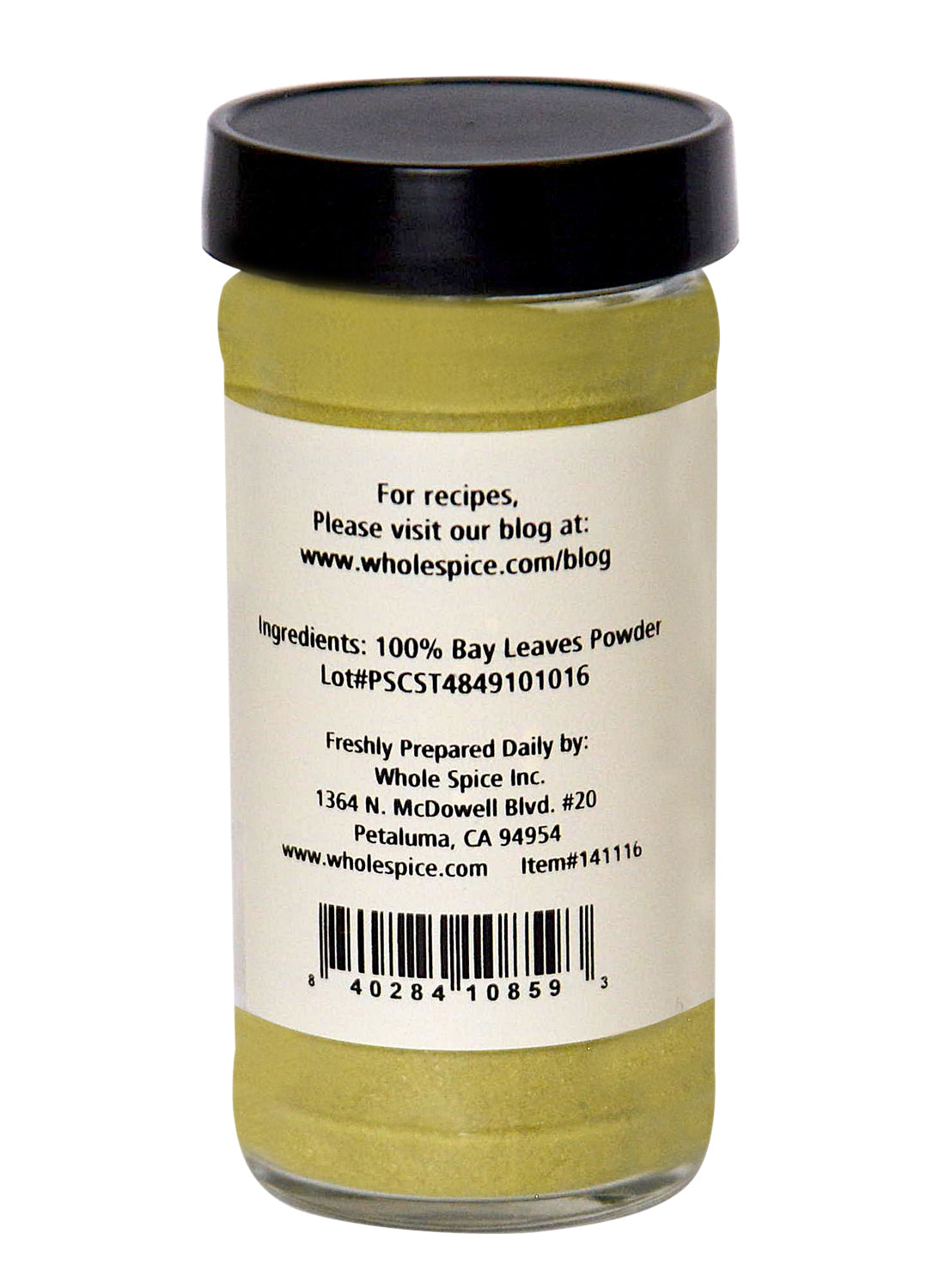 A clear glass jar with a black lid contains Bay Leaves Ground by Whole Spice Inc. The label shows 100% laurus nobilis, prep tips, lot number, and a website for bay leaf recipes.