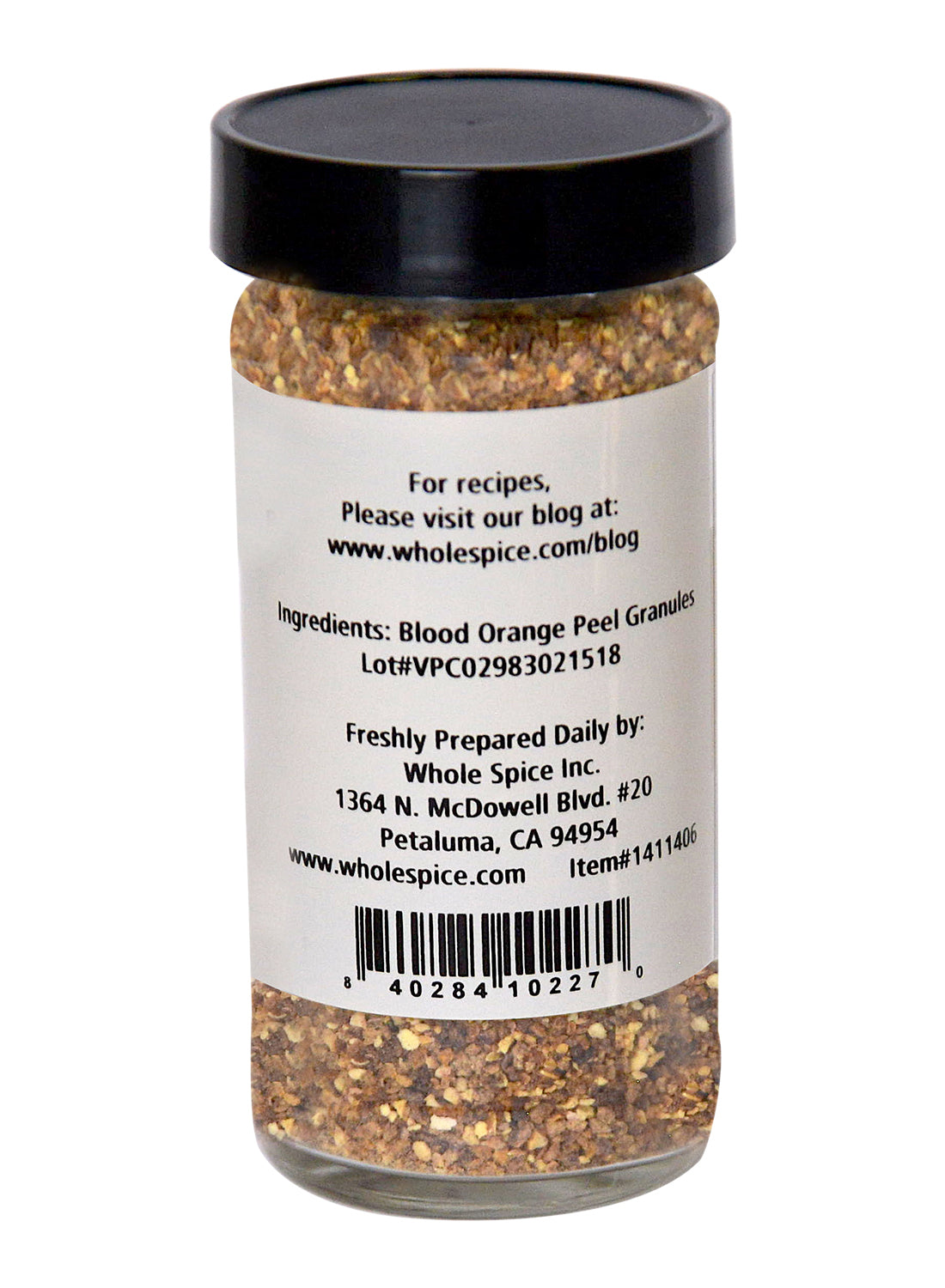A glass jar of Blood Orange Peel Granules by Whole Spice Inc. features a black lid and label with ingredient info, anthocyanin content, usage tips, brand address, website, and barcode—perfect for baking recipes.