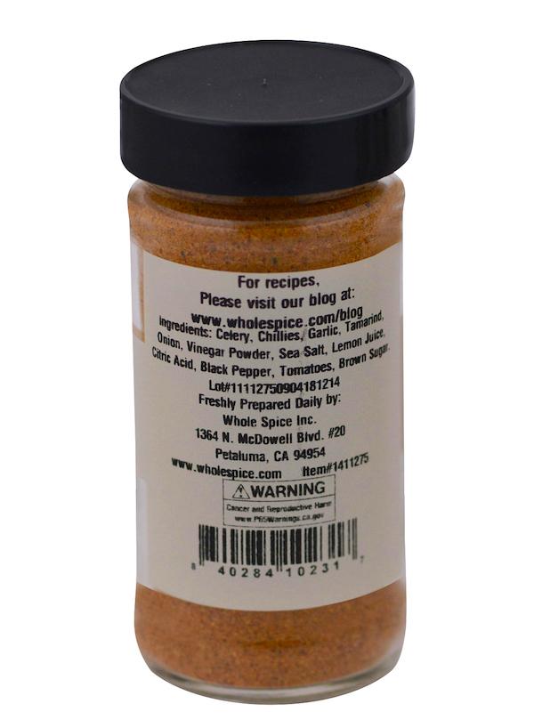 The Whole Spice Inc. Bloody Mary Mix comes in a clear jar with a black lid, labeled with ingredients like celery, chillies, garlic, tamarind, onion, vinegar powder, sea salt, lemon juice, citric acid, black pepper, tomatoes & brown sugar.