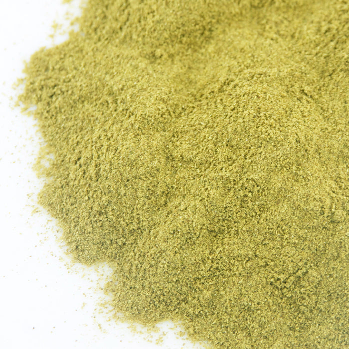 A close-up of Jalapeño Green Chili Powder by Whole Spice Inc., showing a finely ground, greenish pile on a white surface.