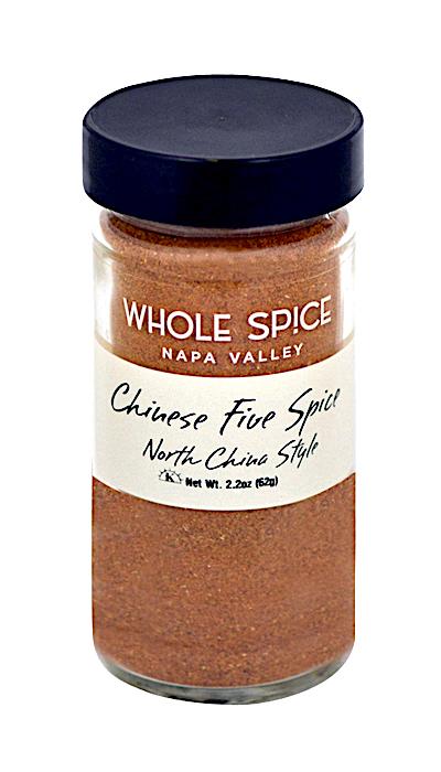 A glass jar with a black lid contains Whole Spice Inc. Chinese Five Spice-North China Style powder, made with Szechuan peppercorns. The jar features a white label with product details in black and brown text.