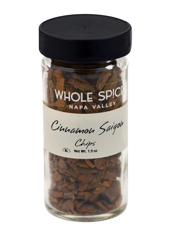 A 1.9 oz glass jar of Whole Spice Inc. Cinnamon Chips Saigon with a black lid, holding aromatic brown cinnamon chips.