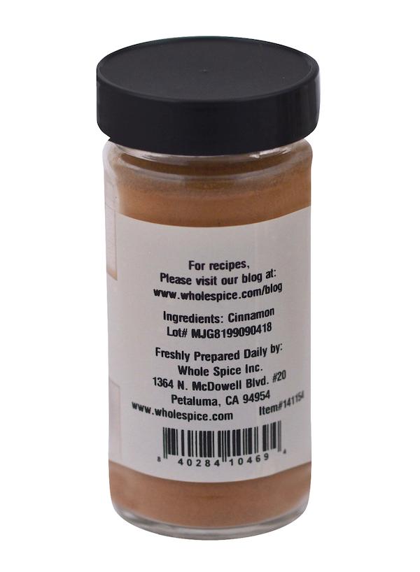 A jar of Whole Spice Inc. Cinnamon Powder with a labeled container, filled with aromatic ground cinnamon.