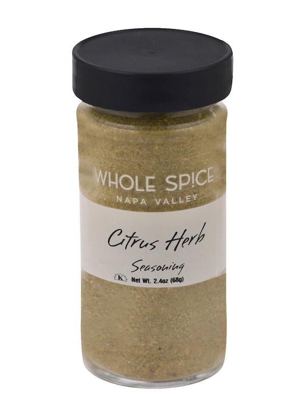 A 2.4 oz (68g) glass jar of Whole Spice Inc. Citrus Herb Seasoning with a black lid, featuring a light brown citrus-lemon blend. Ideal for seafood or adding a fresh, bright flavor to any dish.