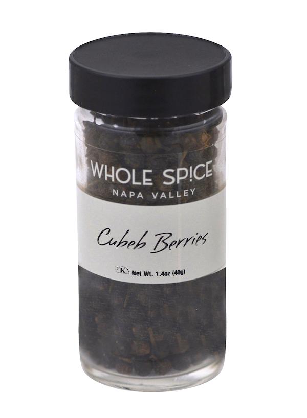 A clear glass jar with a black lid from Whole Spice Inc., labeled Cubeb Berries, contains dark, dried tailed pepper (Java pepper) with a net weight of 1.4 oz (40g).