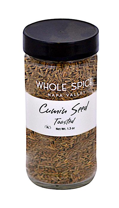 A clear glass jar with a black lid holds Whole Spice Inc. Cumin Seed Whole Toasted. The label states Net Wt. 1.3 oz.