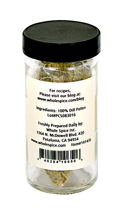 A clear spice jar with a black lid contains Dill Pollen by Whole Spice Inc., featuring 100% dill pollen as the ingredient; ideal for seasoning fish. The label includes contact info and a barcode at the bottom.