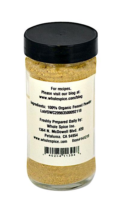 A clear spice jar with a black lid contains light brown Fennel Seed Powder Organic by Whole Spice Inc., made from ground fennel seeds, featuring the brand’s address and website on the label.