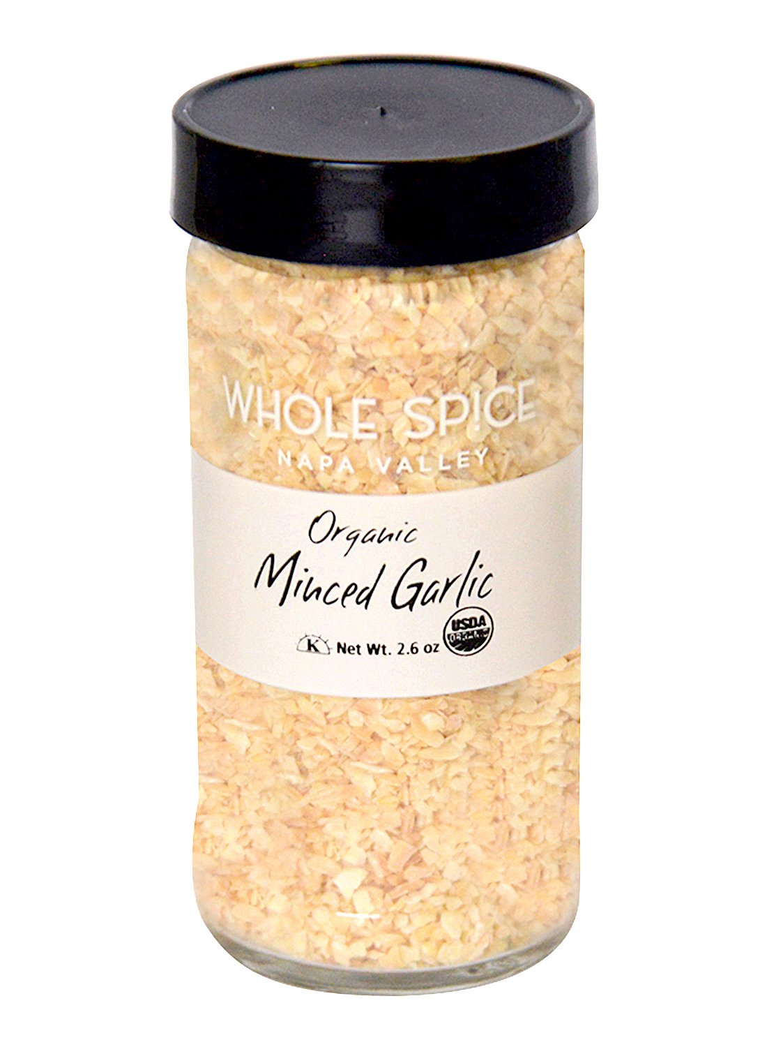 A clear glass jar of Whole Spice Inc. Garlic Minced Organic with a black lid, filled with small dried garlic pieces. Net weight: 2.6 oz. Features the USDA Organic seal—ideal for adding garlic flavor to any dish.