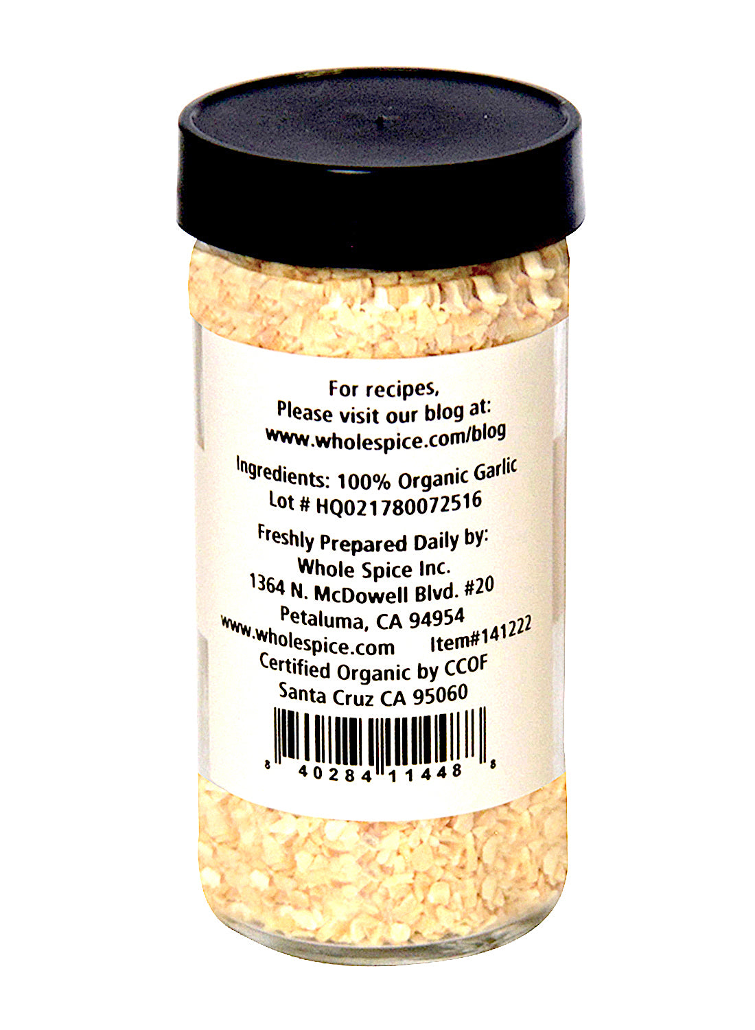 A clear jar with a black lid holds Whole Spice Inc. Garlic Minced Organic. The label features ingredient info, lot number, prep tips, and contact details. Ideal as an organic garlic seasoning for your dishes.