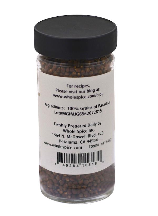 A jar of Grains of Paradise by Whole Spice Inc., featuring brown seeds and a label highlighting this exotic spice, also known as Melegueta pepper.