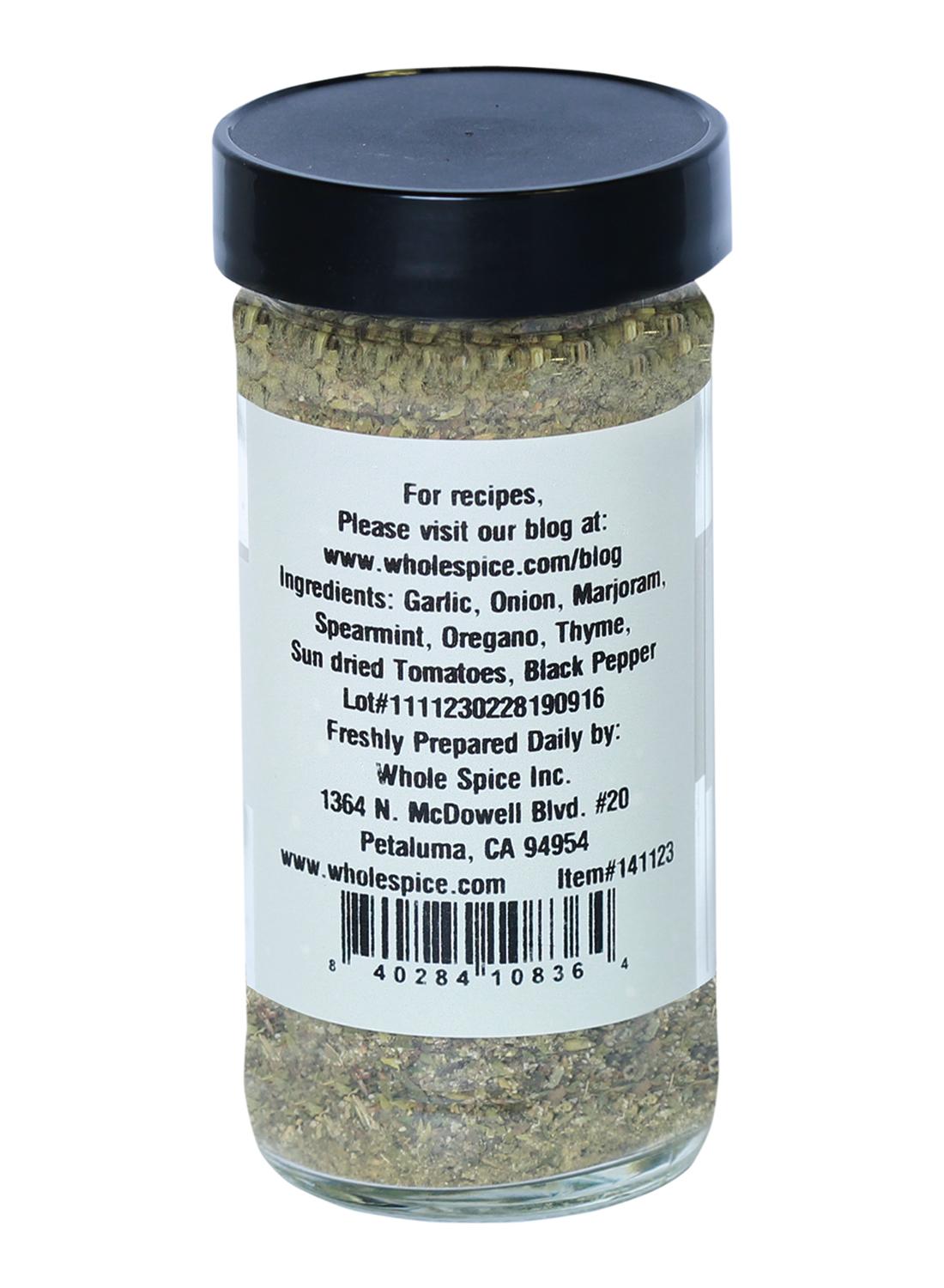 Greek Seasoning by Whole Spice Inc. comes in a glass jar with a white label, featuring ingredients like garlic, onion, herbs, and spices—ideal for pasta salads or as a meat rub. Manufacturer details are provided.