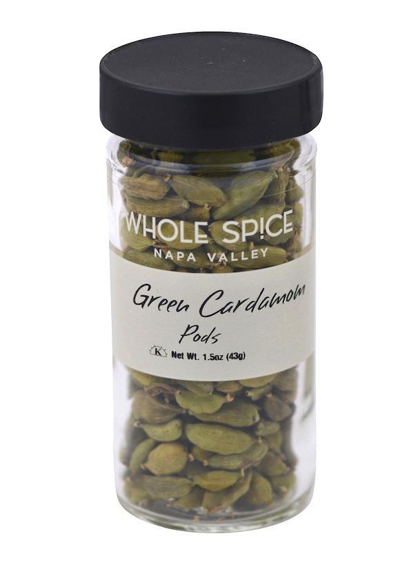 A clear glass jar with black lid, filled with Whole Spice Inc. Green Cardamom Pods—ideal for Indian tea; label notes net weight 1.5 oz (43g).