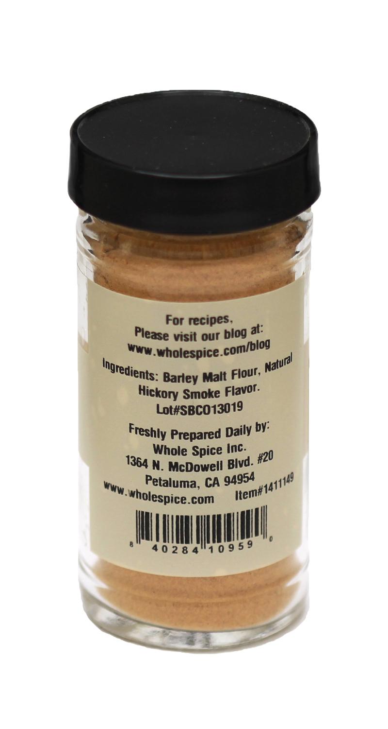 Whole Spice Inc. Hickory Powder comes in a clear jar with a black lid, holding beige powder for smoky flavor. The back label shows ingredients, company info (Petaluma, CA), and a barcode.