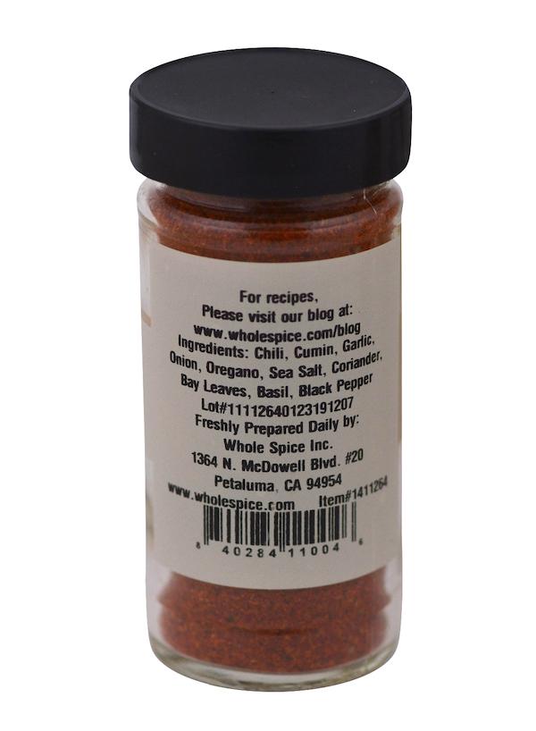 Istanbul Grill Seasoning by Whole Spice Inc. comes in a clear jar with a black lid and white label listing chili, cumin, garlic, onion, oregano, and bay leaves—ideal for Mediterranean cuisine. Whole Spice Inc. contact info is included.