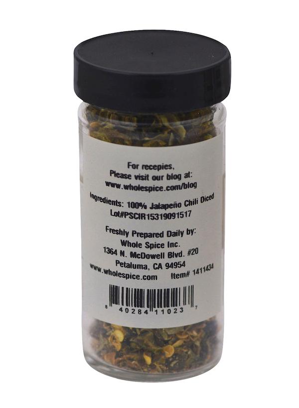 Whole Spice Inc. Jalapeño Green Chili Diced comes in a clear plastic jar with a black lid. The label states the ingredient is 100% diced jalapeño chili and includes manufacturer contact and address details.