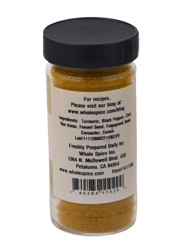 A clear spice jar with a black lid from Whole Spice Inc. displays Japanese Curry, a yellowish blend with turmeric and black pepper. The label features the Petaluma, CA address and website for curry rice and coconut curry sauce recipes.