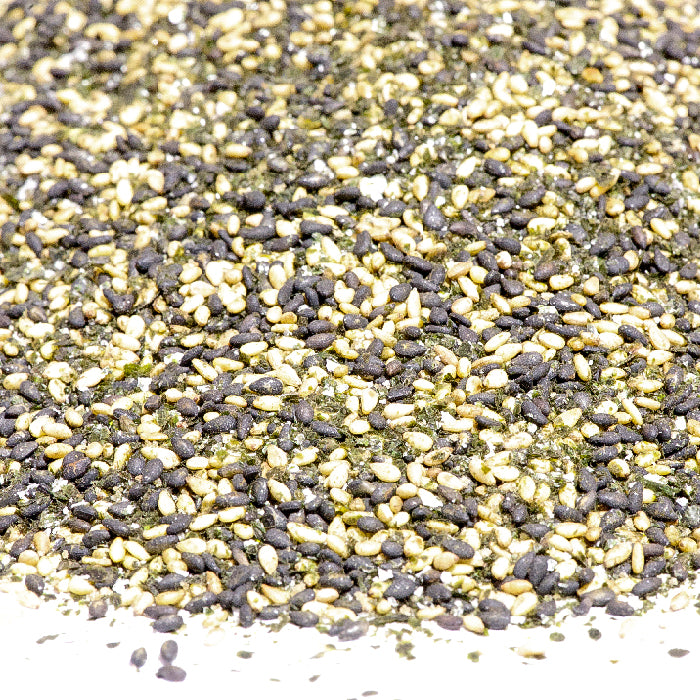 A close-up of Japanese RiceSeaweed Seasoning - Classic by Whole Spice Inc., showing a blend of black and white sesame seeds, dried seaweed flakes, and other small dried ingredients.