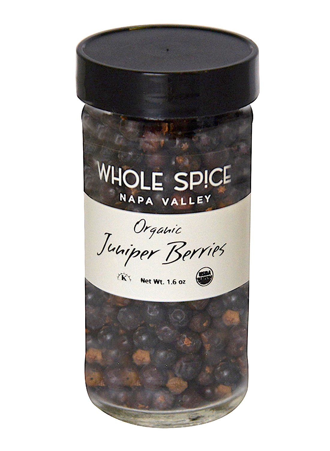 A clear glass jar of Whole Spice Inc. Juniper Berries Organic with a black lid and white label, filled with pine-flavored berries ideal for Scandinavian dishes. Net weight: 1.6 oz.