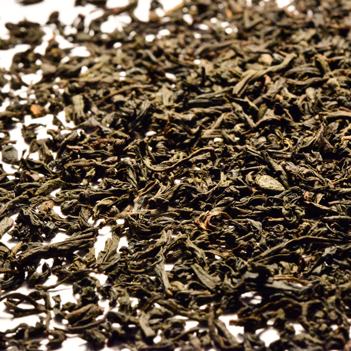 A pile of green leaves, capturing the bold aroma of Lapsang Souchong Tea by Whole Spice Inc.