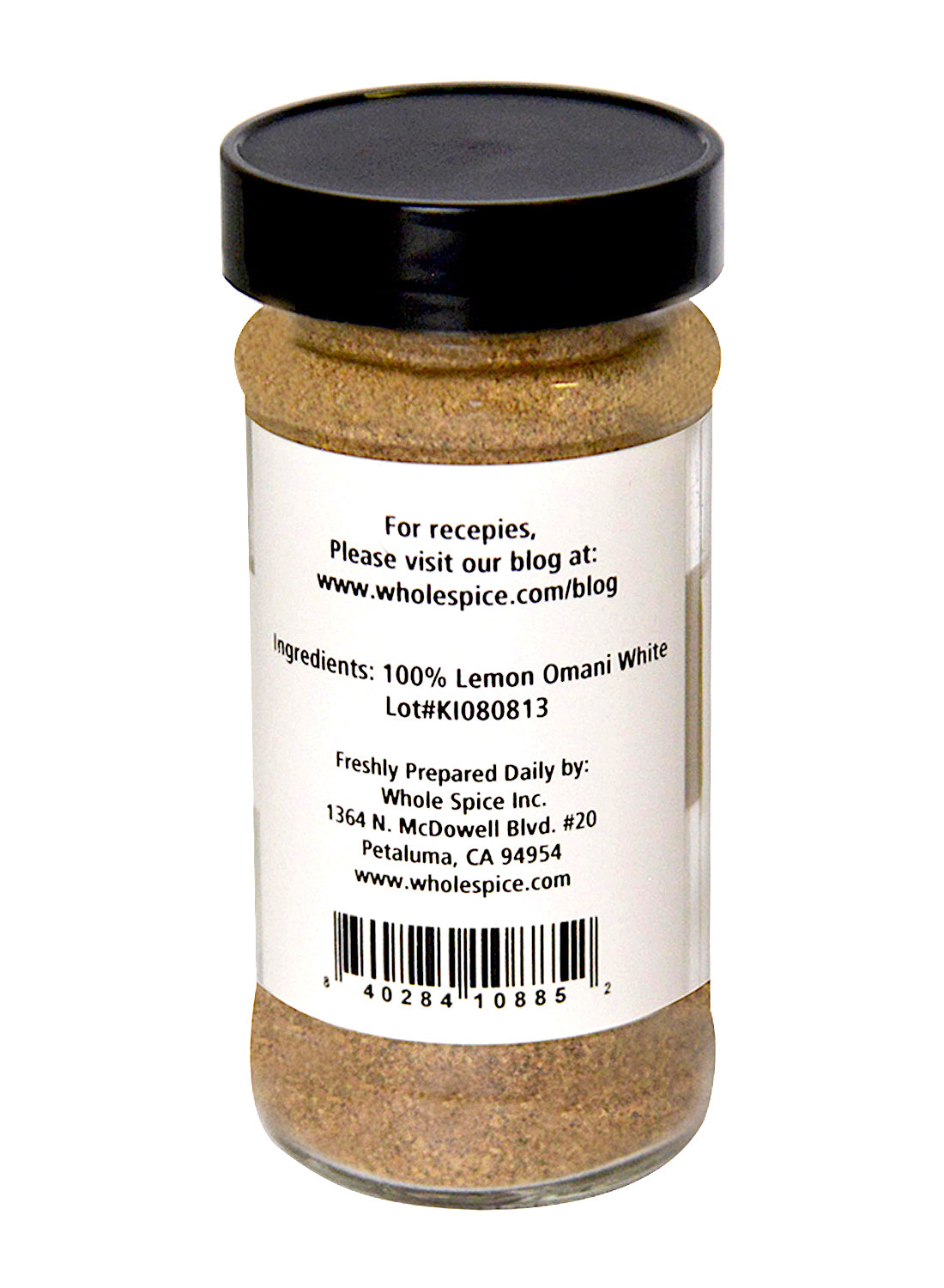 A clear spice jar with a black lid holds Lemon Omani White Ground by Whole Spice Inc., a finely ground souring agent made from Omani lemons. The label features the product name and contact details for Whole Spice Inc.