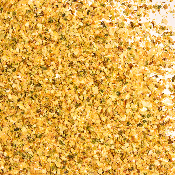 A pile of yellow flakes made from dried lime zest, called Lime Peel Granules by Whole Spice Inc.