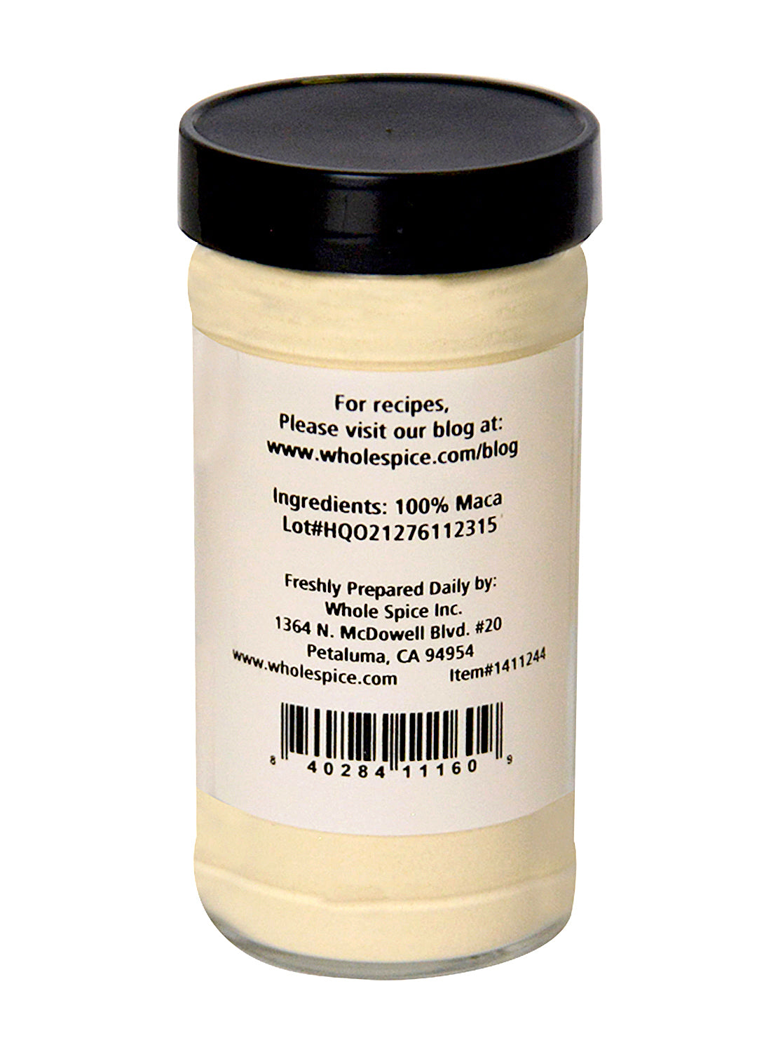 A clear spice jar with a black lid contains Whole Spice Inc. Maca Powder, labeled on the back with 100% maca root, company address, barcode, and website—a premium superfood herb.