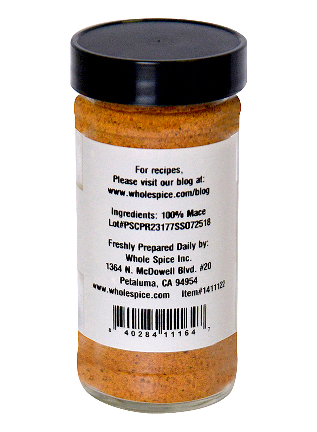 A clear jar of Whole Spice Inc. Mace Powder shows orange-brown ground mace labeled “100% Mace.” The label includes manufacturer info, a recipe website, and a barcode. A black lid keeps this nutmeg alternative fresh.