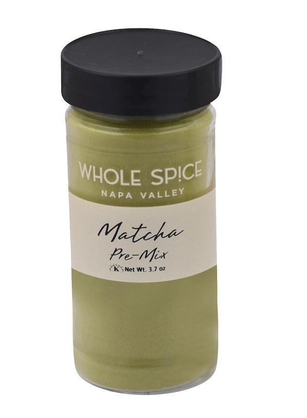 A clear jar with a black lid labeled Whole Spice Inc. Matcha Pre-Mix, Net Wt. 3.7 oz, contains light green powder—ideal for making premium Matcha green tea and tasty Matcha drinks.