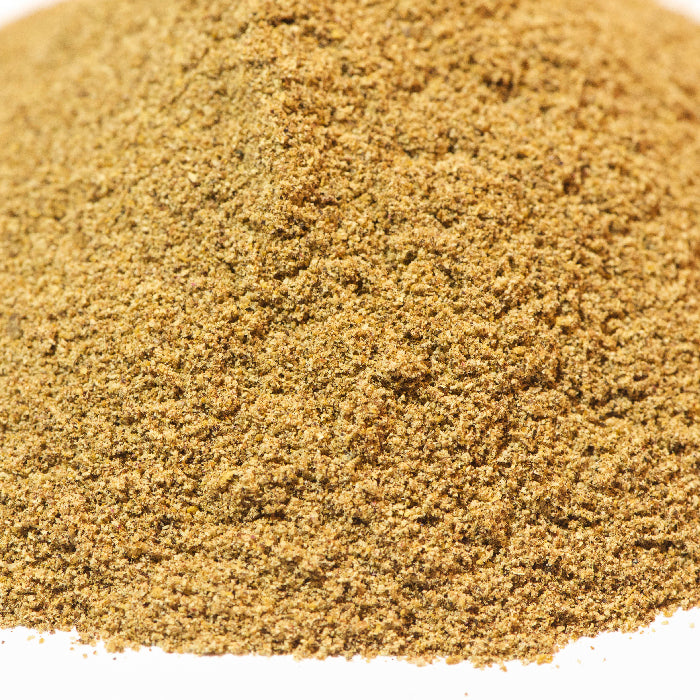 A close-up of finely ground brownish-green Moroccan Meatball Spice Mix by Whole Spice Inc., displayed against a white background.