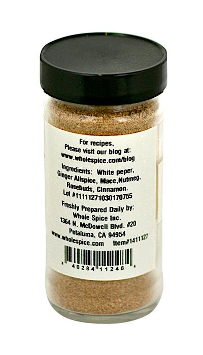A clear spice jar with a black lid features the Whole Spice Inc. Moroccan Meatball Spice Mix label, listing white pepper, allspice, mace, nutmeg, ginger, rosebuds, and cinnamon. Label includes contact and product info.