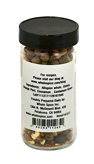 A clear jar with a black lid from Whole Spice Inc. contains Mulling Spices, a blend of allspice, cloves, orange peel, cinnamon, and cardamom for mulled wine. The label includes company and contact details.
