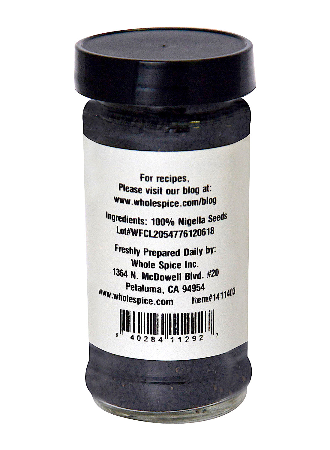 A clear spice jar with a black lid from Whole Spice Inc. contains Nigella Seed. The white label lists “Ingredients: 100% Nigella Seed,” company info, and is perfect for panch phoron or pickling spice blends.