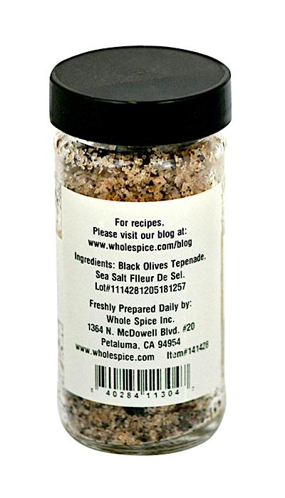 Olive Salt by Whole Spice Inc. comes in a glass jar with a black lid and features a gourmet blend of fleur de sel sea salt and black olive tapenade—ingredients and company info appear on the label.