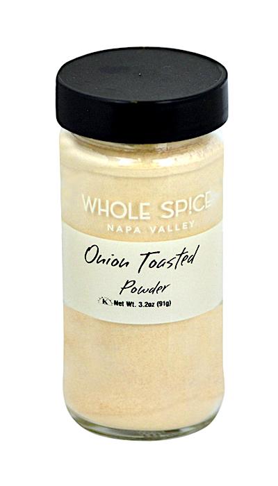 A clear glass jar with black lid, labeled Whole Spice Inc. Onion Toasted Powder, Net Wt. 3.2oz (91g), contains light beige dehydrated onion powder—ideal for enhancing soups or savory dishes.