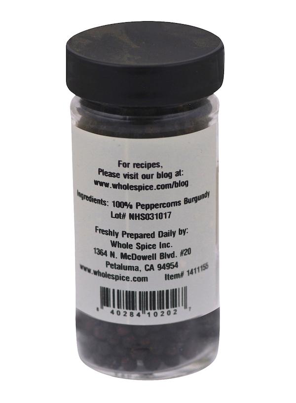 Peppercorns Burgundy by Whole Spice Inc. comes in a clear plastic jar with a black lid, filled with whole black pepper berries from Quang Tri, Vietnam. The label states 100% peppercorns and lists company contact details plus a recipe website.