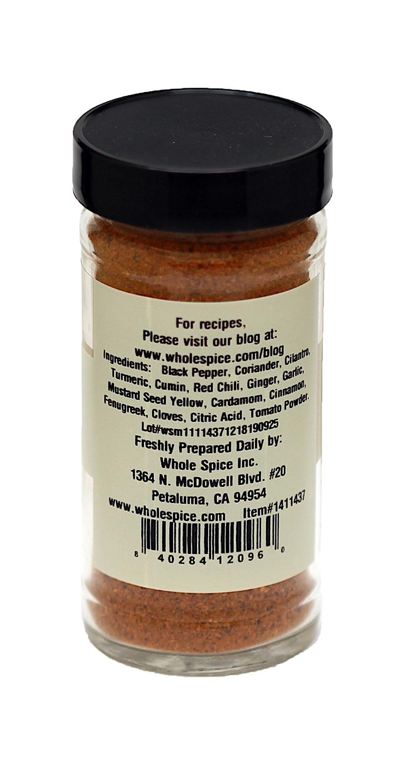 A clear spice jar with a black lid and white label holds Vindaloo Curry Powder by Whole Spice Inc.—a reddish-brown blend ideal for adding authentic Vindaloo flavor to Goan cuisine and Indian curry dishes. Label includes ingredients, company info, and barcode.