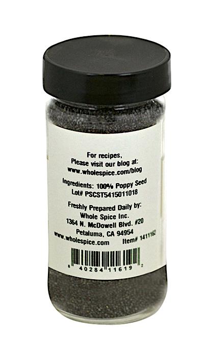 A clear spice jar with a black lid from Whole Spice Inc. contains Poppy Seeds. The label lists 100% poppy seed as the ingredient, plus preparation tips and company info—ideal for cooking or pastry fillings.