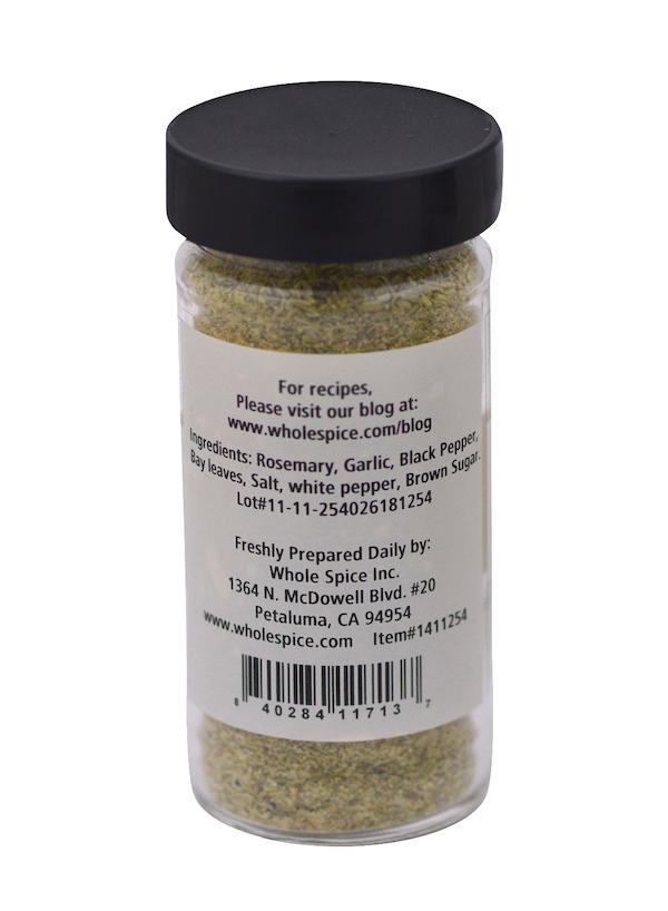 Whole Spice Inc. Rosemary & Garlic Rub comes in a clear jar with a black lid and greenish seasoning inside. The back label lists ingredients, preparation tips, and Whole Spice's Petaluma, CA contact info. Great as a meat seasoning or herb rub.